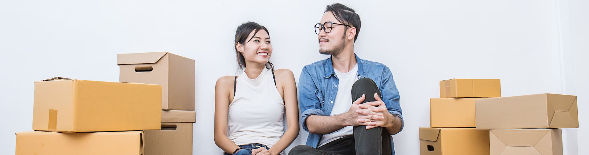 Young couple packing and moving their house. SME or freelance woman and man siting on the floor working at home concept, online marketing packaging and delivery, SME concept